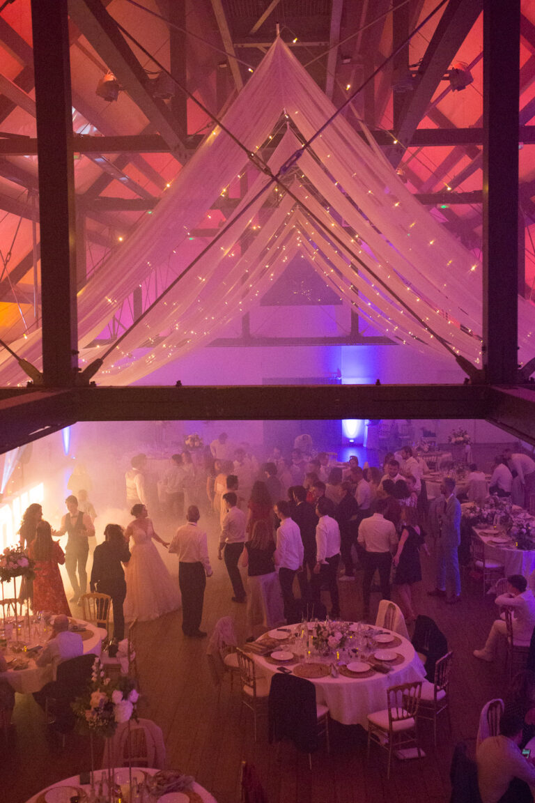 Vue d'en haut sur la charpente et les invités en train de danser lors de la soirée